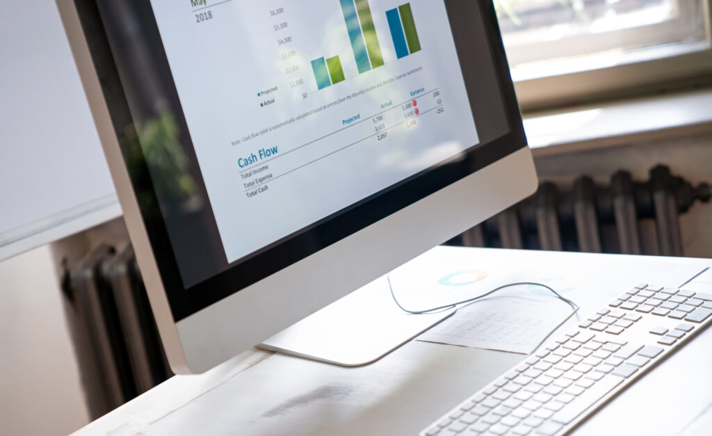 Close-up of the screens of personal computer with diagram, statistics at workplace in the office.