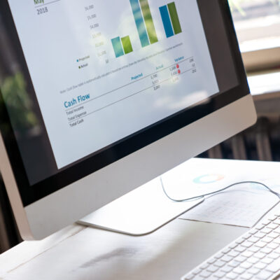 Close-up of the screens of personal computer with diagram, statistics at workplace in the office.